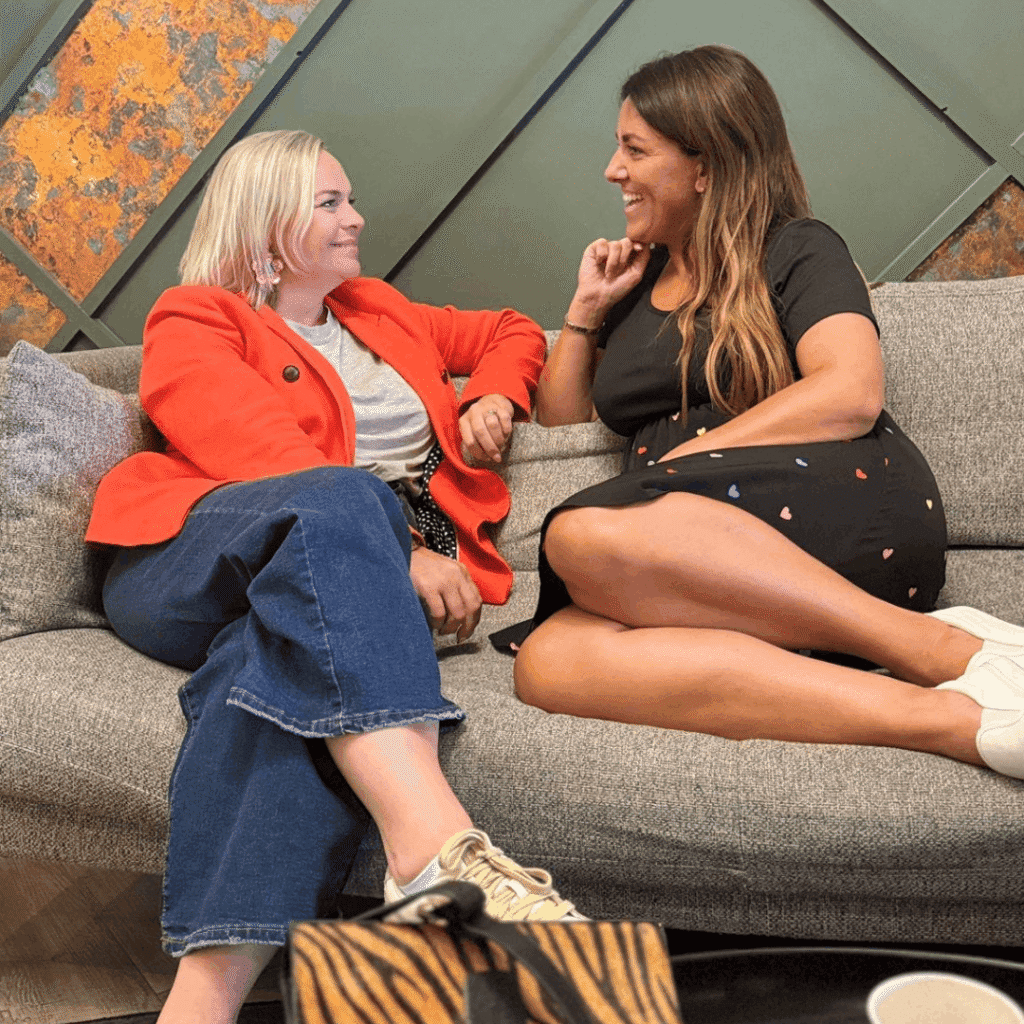 Natalie sitting on a settee facing a lady also sitting on the settee