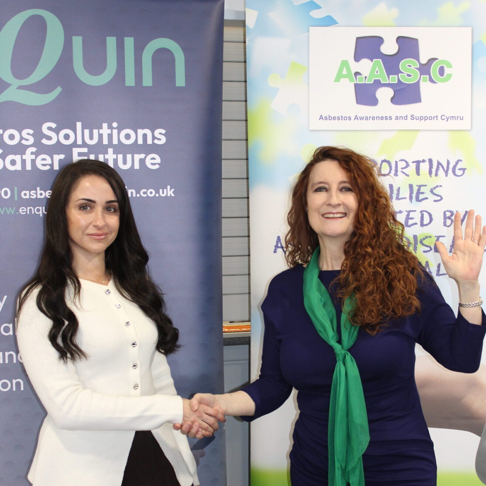 Two ladies shaking hands and advertising Quin